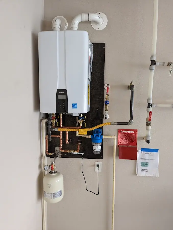 Professional plumber installing copper piping in a Madill home